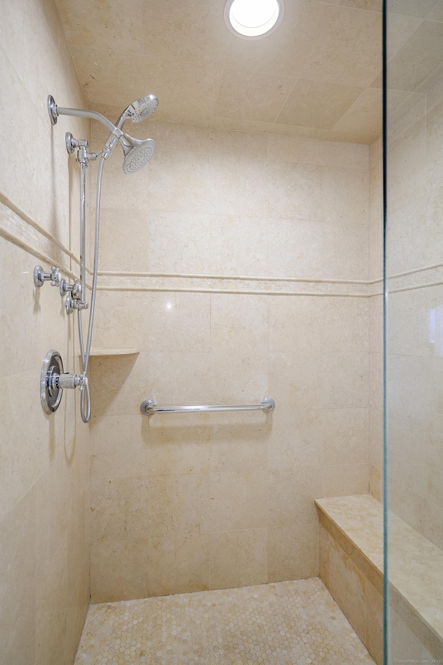 bathroom with tiled shower