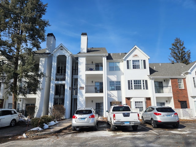 view of property featuring uncovered parking