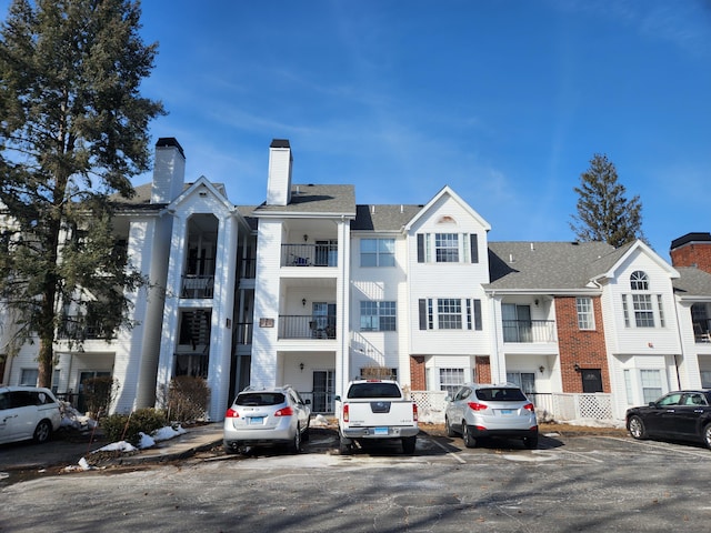 view of building exterior featuring uncovered parking