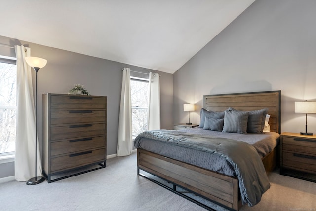 carpeted bedroom with lofted ceiling