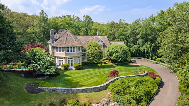 4 Hemlock Rdg, Weston, CT 06883 - view of front of house featuring a chimney, a front lawn, and a forest view