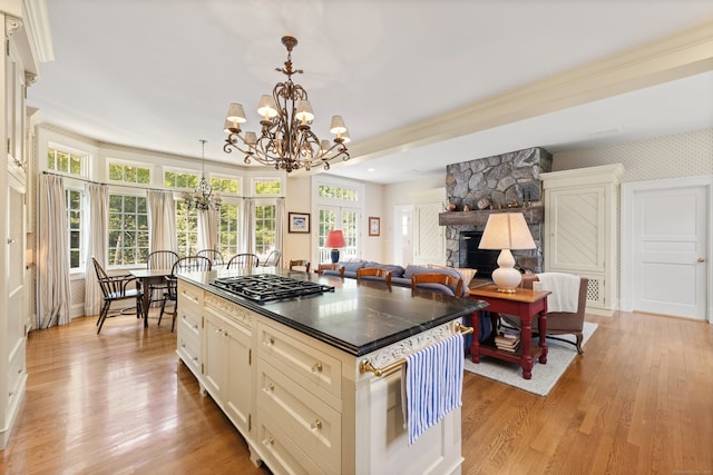 4 Hemlock Rdg, Weston, CT 06883 - kitchen featuring stainless steel gas stovetop, a chandelier, light wood-type flooring, and dark countertops