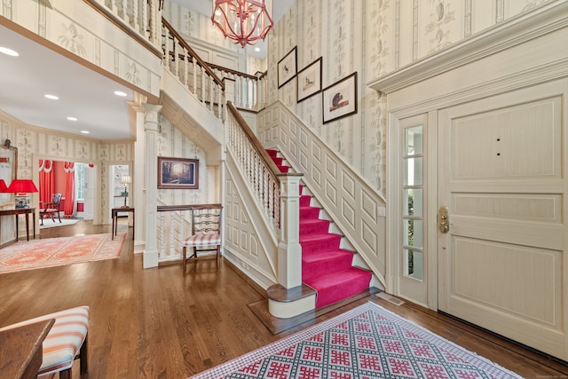 4 Hemlock Rdg, Weston, CT 06883 - entryway featuring wallpapered walls, crown molding, stairs, wood finished floors, and a high ceiling