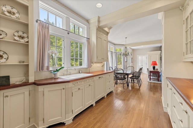 4 Hemlock Rdg, Weston, CT 06883 - kitchen with butcher block countertops, a chandelier, light wood-type flooring, hanging light fixtures, and glass insert cabinets
