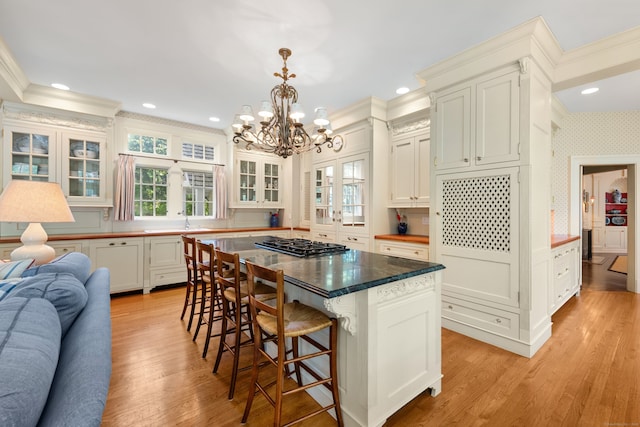 4 Hemlock Rdg, Weston, CT 06883 - kitchen featuring crown molding, a chandelier, open floor plan, plenty of natural light, and glass insert cabinets