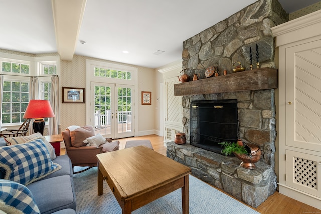 4 Hemlock Rdg, Weston, CT 06883 - living area with wood finished floors, beamed ceiling, plenty of natural light, french doors, and a stone fireplace