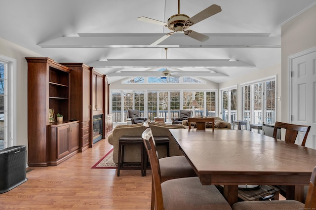 dining area with lofted ceiling with beams, light wood finished floors, and a ceiling fan