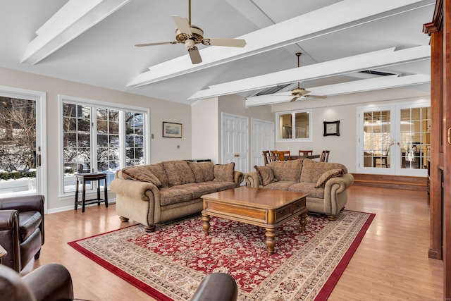 living area featuring light wood-type flooring, french doors, ceiling fan, and lofted ceiling with beams