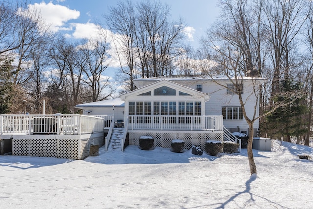 snow covered property featuring stairway and a wooden deck