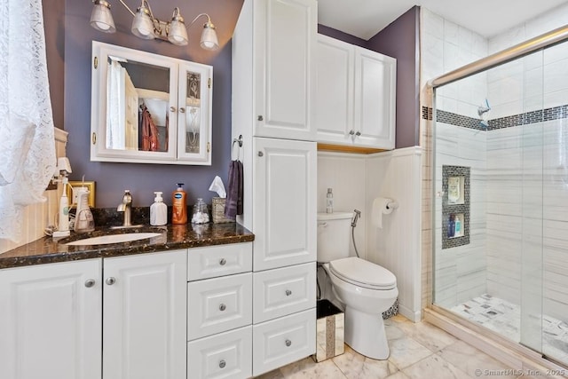 full bathroom with toilet, a shower stall, and vanity