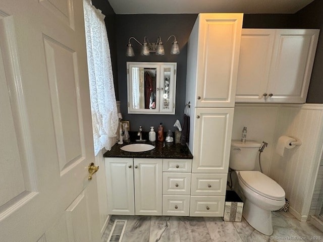 full bathroom featuring toilet, marble finish floor, visible vents, and vanity