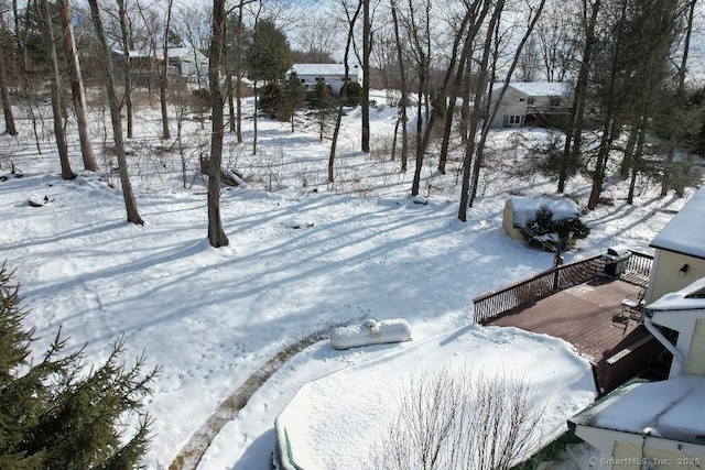 snowy yard featuring a deck