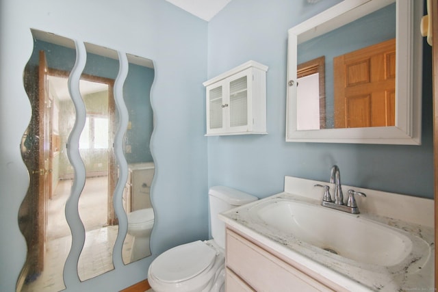 bathroom with vanity and toilet