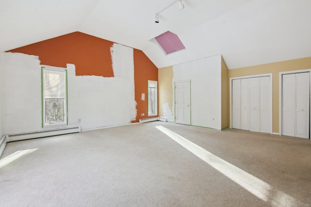 bonus room featuring light carpet, vaulted ceiling, and a baseboard radiator