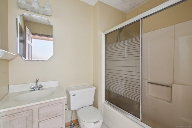 full bathroom featuring shower / bath combination with glass door, vanity, and toilet