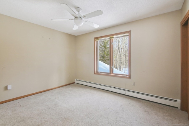 empty room with baseboards, ceiling fan, carpet, a textured ceiling, and a baseboard heating unit