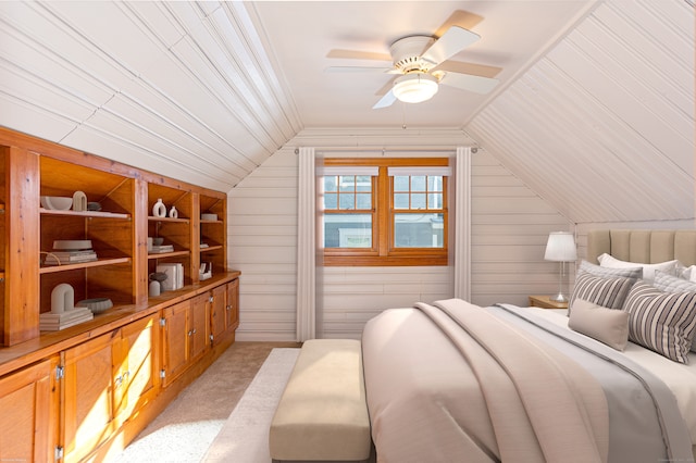 carpeted bedroom with lofted ceiling, wooden walls, and ceiling fan