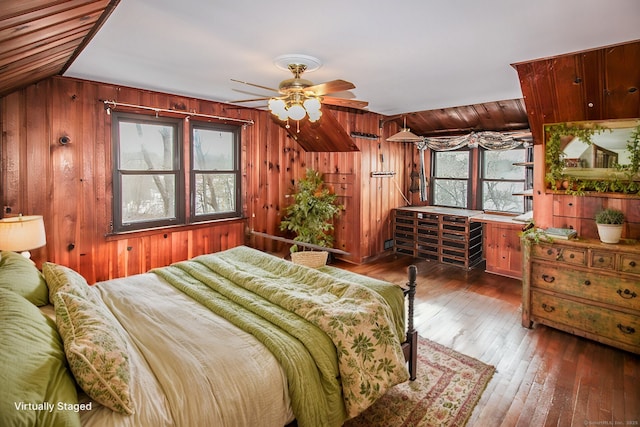 bedroom featuring wood-type flooring and wood walls