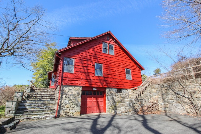 279 Candlewood Lake Rd, Brookfield, CT 06804 - view of home's exterior with aphalt driveway, stairs, and a garage