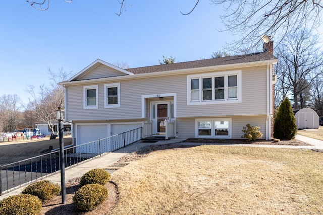 raised ranch featuring entry steps, an attached garage, fence, and a chimney