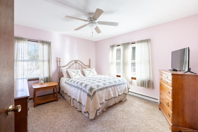 bedroom featuring a ceiling fan, light colored carpet, and a baseboard radiator