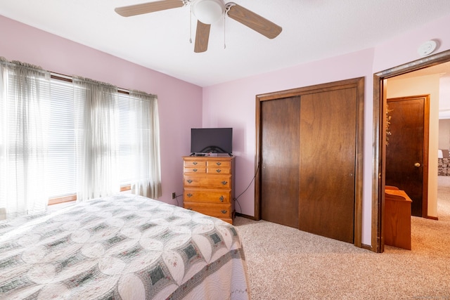 bedroom featuring a closet, carpet, and a ceiling fan