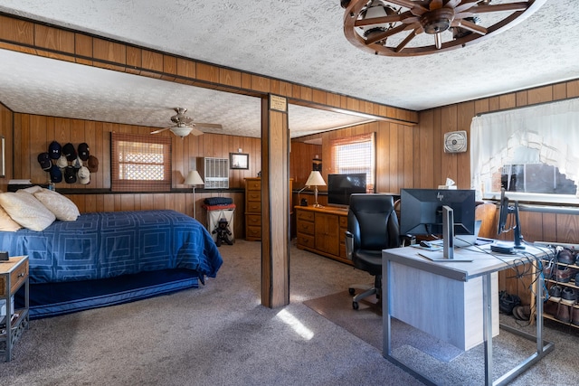 carpeted bedroom featuring wooden walls and a textured ceiling