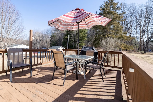 wooden terrace with outdoor dining space