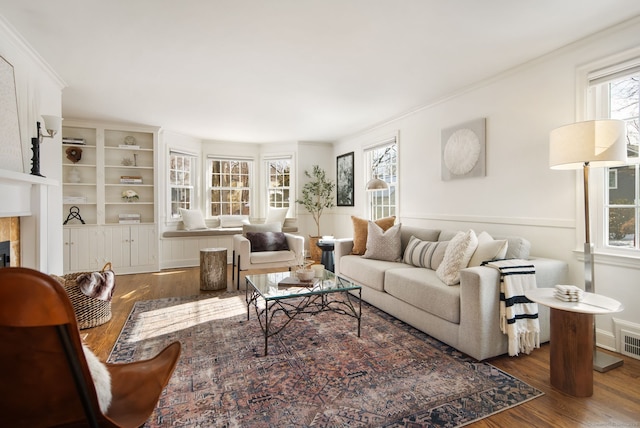 living room with ornamental molding and dark wood-type flooring