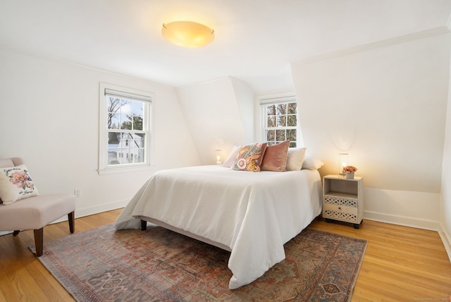 bedroom featuring multiple windows and hardwood / wood-style flooring