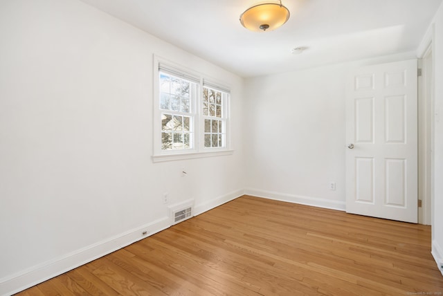 spare room with light hardwood / wood-style flooring