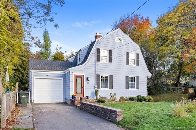 view of front of home with a garage and a front lawn