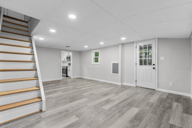 basement with light hardwood / wood-style floors