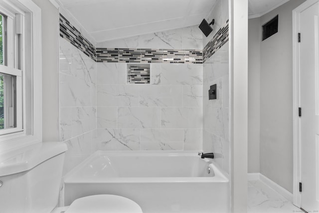 bathroom featuring tiled shower / bath and toilet