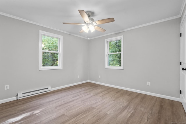 empty room featuring a wealth of natural light, a baseboard radiator, ornamental molding, and light hardwood / wood-style floors