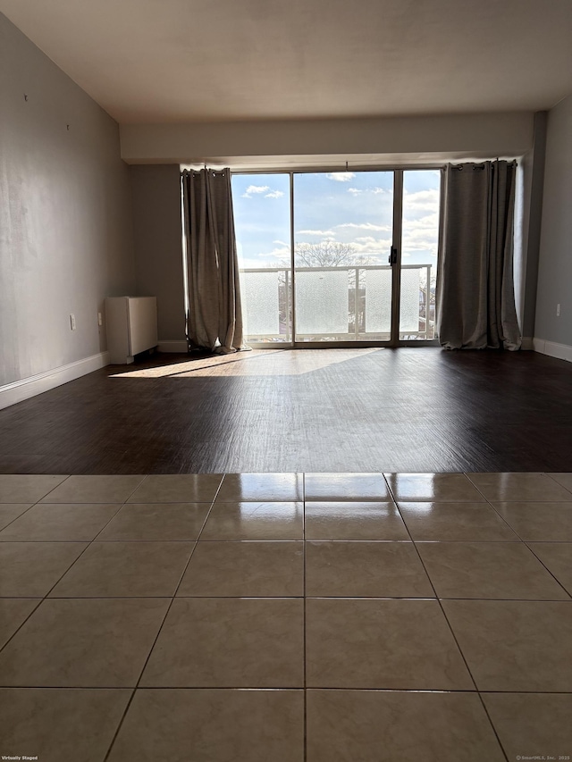 empty room with dark tile patterned floors