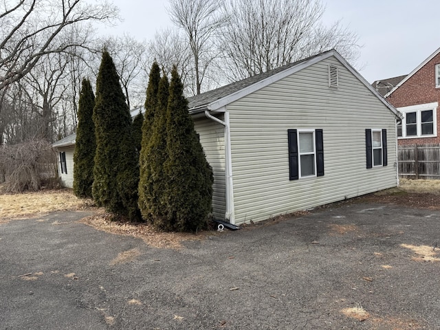 view of side of home with fence