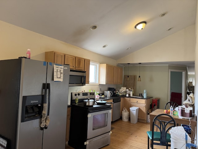 kitchen with dark countertops, lofted ceiling, light wood-style flooring, appliances with stainless steel finishes, and decorative light fixtures