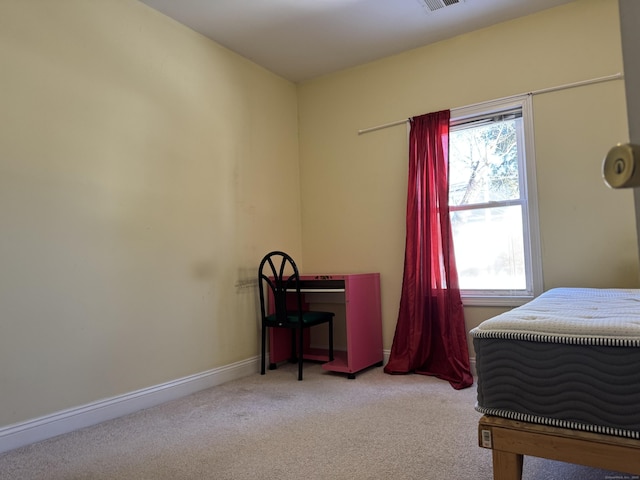 bedroom with visible vents, multiple windows, baseboards, and light colored carpet