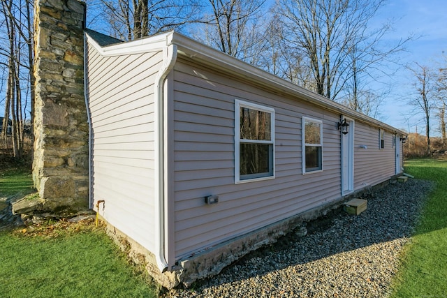 view of property exterior with a yard