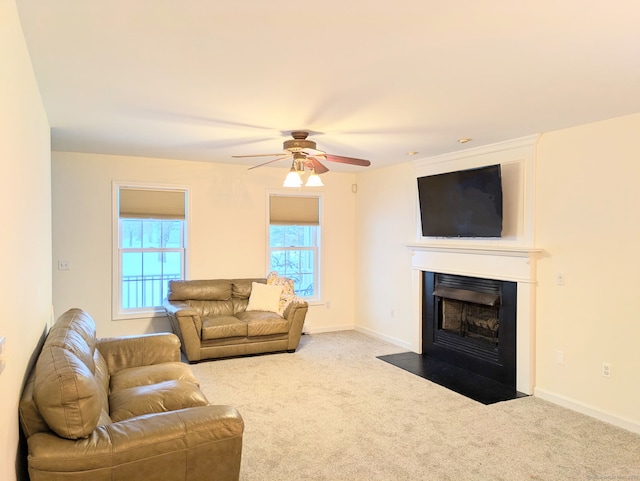 living room with ceiling fan and carpet flooring