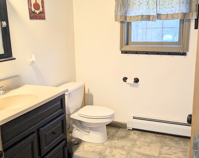 bathroom with a baseboard radiator, vanity, and toilet