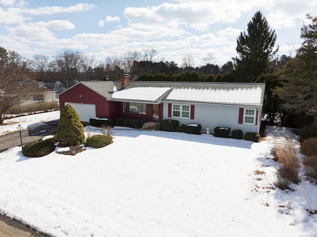 single story home with a chimney and an attached garage