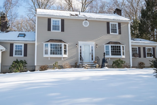 colonial house with entry steps and a chimney