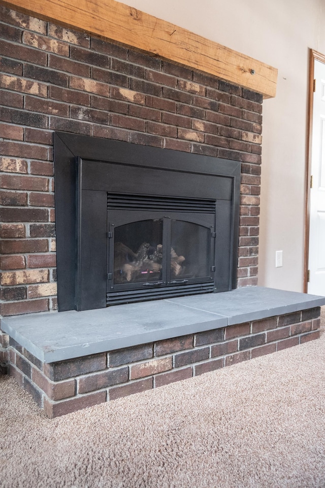 interior details with carpet floors and a fireplace