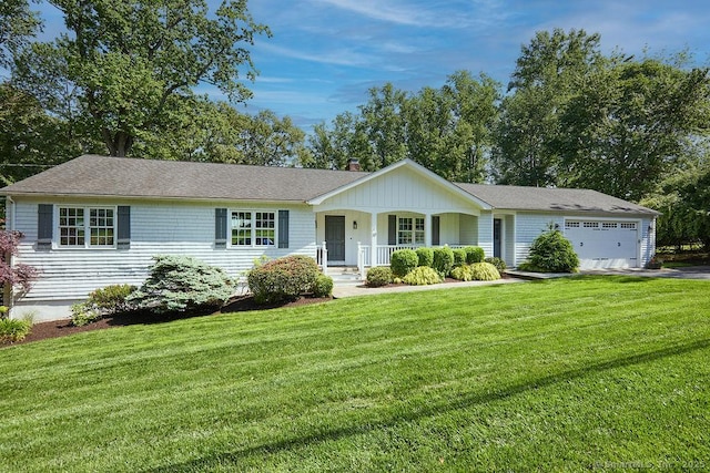 ranch-style home with a garage, covered porch, driveway, a chimney, and a front yard