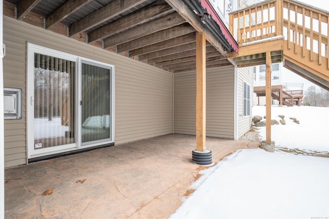 snow covered patio with stairs