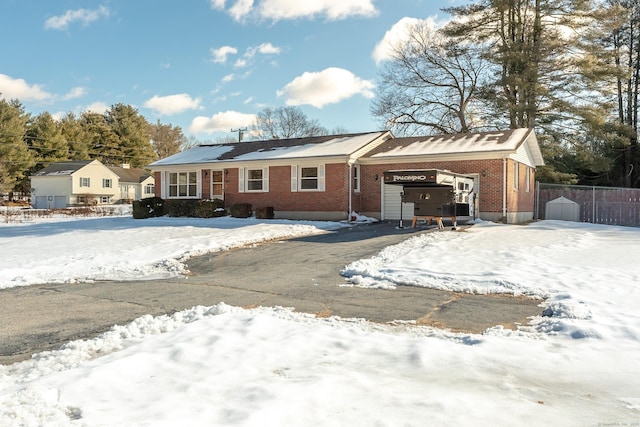 view of front facade with brick siding, a carport, and fence