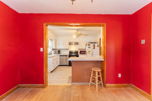 kitchen with electric range, white refrigerator with ice dispenser, range hood, white cabinetry, and dishwasher