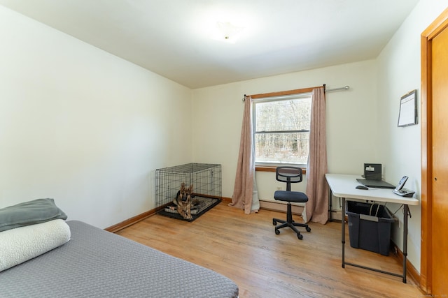 bedroom featuring baseboards and light wood finished floors